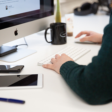 A web designer working on a Mac